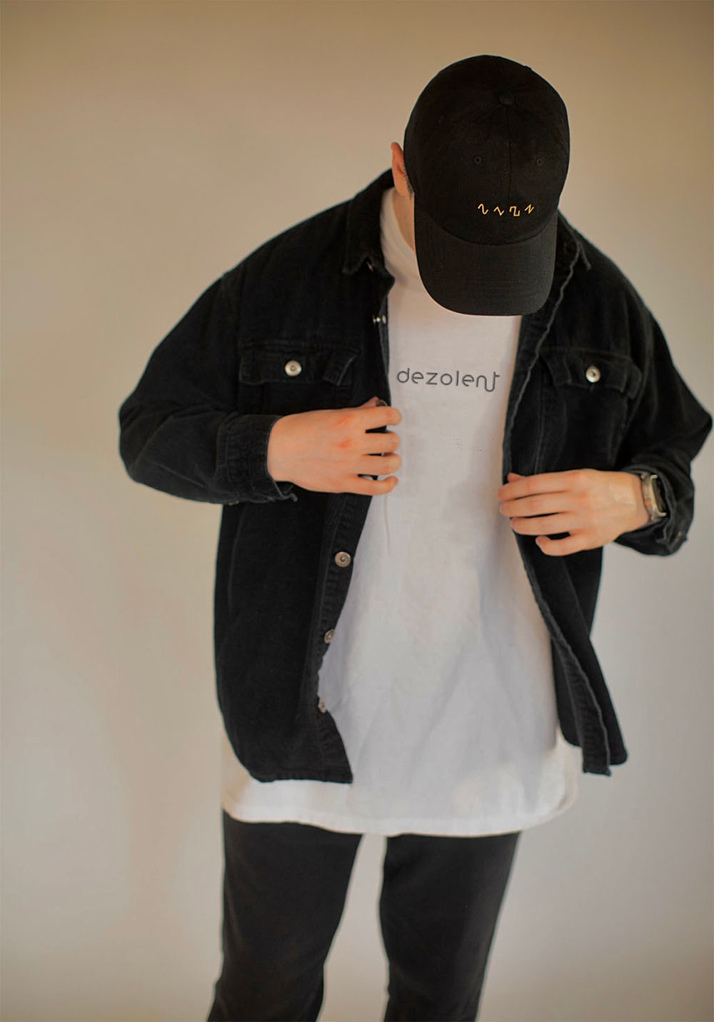 Model Wearing the Dezolent Signature White Garment Dyed Heavyweight Comfort Colors Tee and Basic Shapes Black Dad Hat